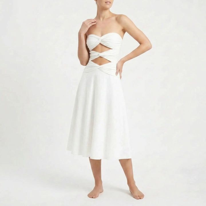 Women's two-piece resort outfit: cutout bandeau swimsuit & elegant long skirt.