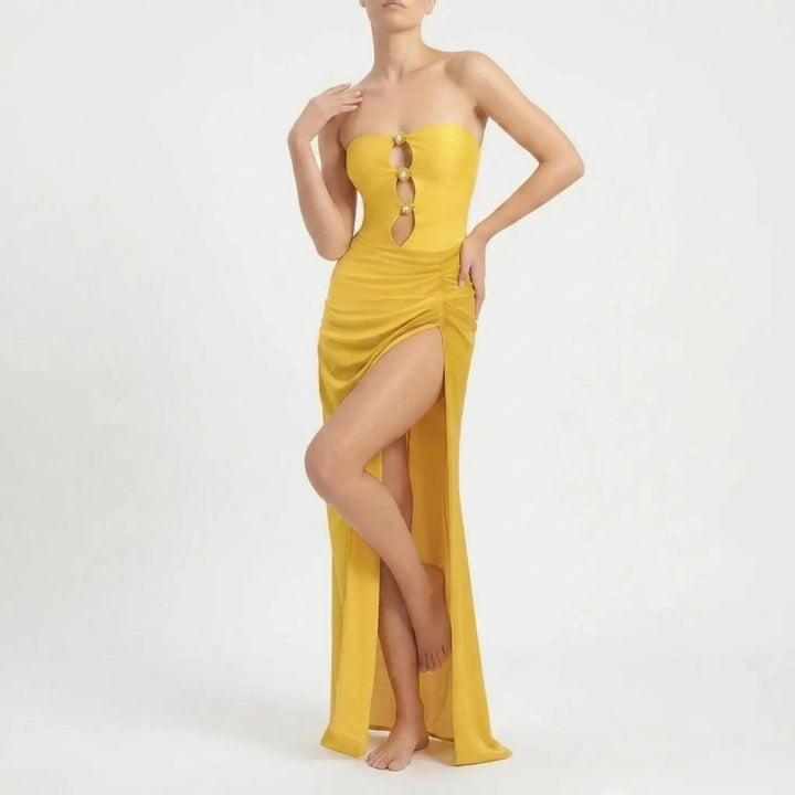 Stylish women's two-piece beach outfit: cutout top, bottom, and a long flowy skirt cover-up.
