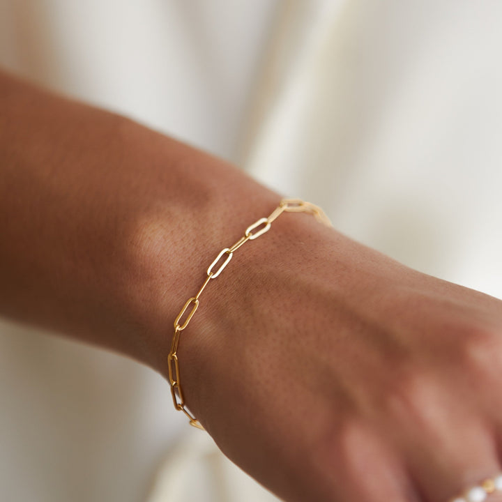 Women's dainty gold paperclip link chain bracelet. Minimalist & stackable, perfect for everyday wear. Hypoallergenic.