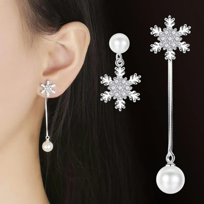 Women's dainty sterling silver snowflake drop earrings, elegant winter jewelry, perfect festive fashion accessory.