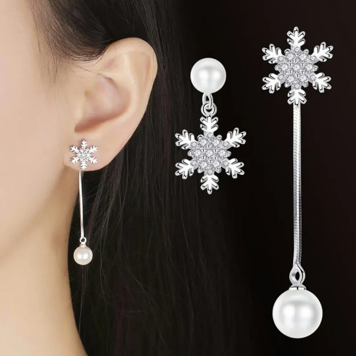Women's dainty sterling silver snowflake drop earrings, elegant winter jewelry, perfect festive fashion accessory.