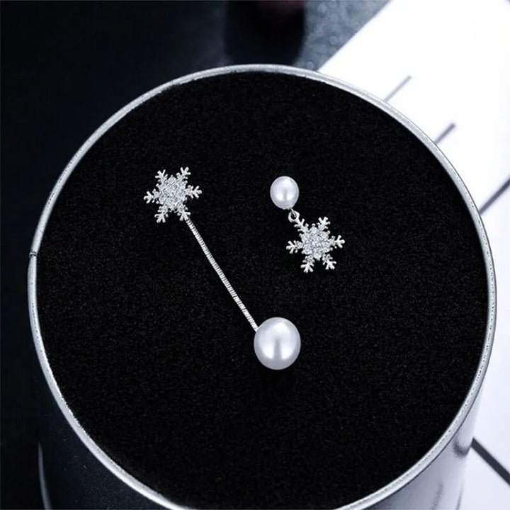 Festive & elegant sterling silver snowflake drop earrings, perfect dainty winter jewelry fashion accessory.