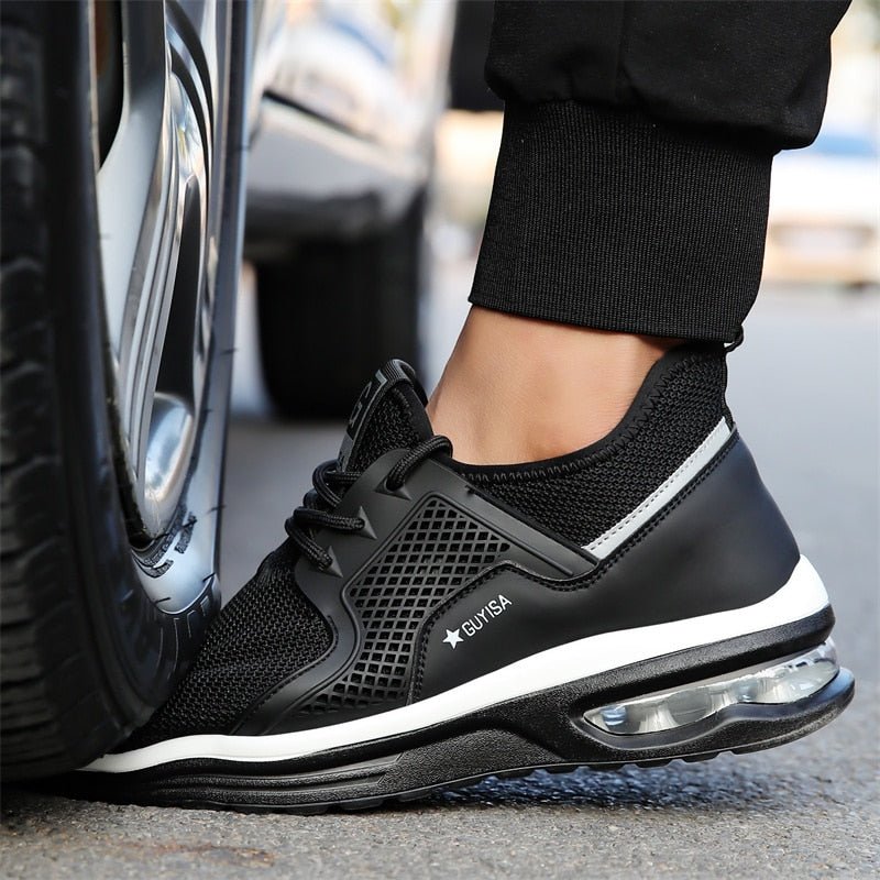 Black & dark gray protective safety sneakers for women, featuring steel toe and slip-resistant grip.