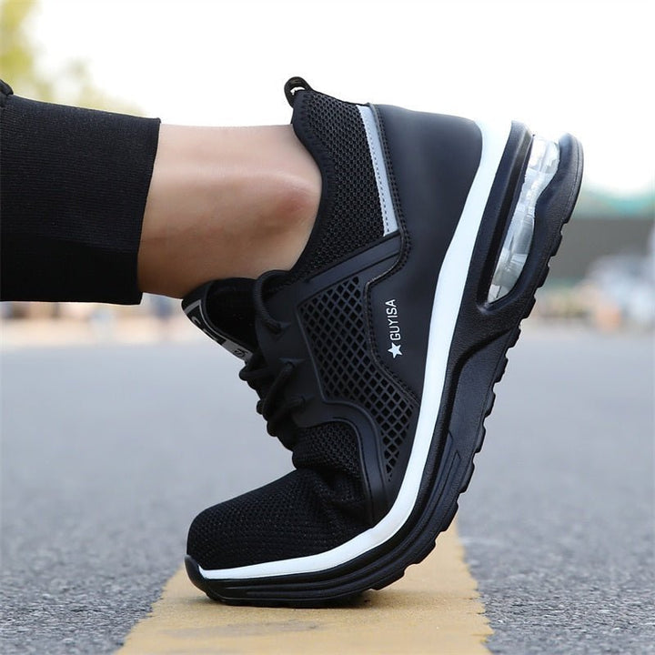 Durable dark gray women's safety sneakers for industrial work, offering slip resistance and steel toe protection.