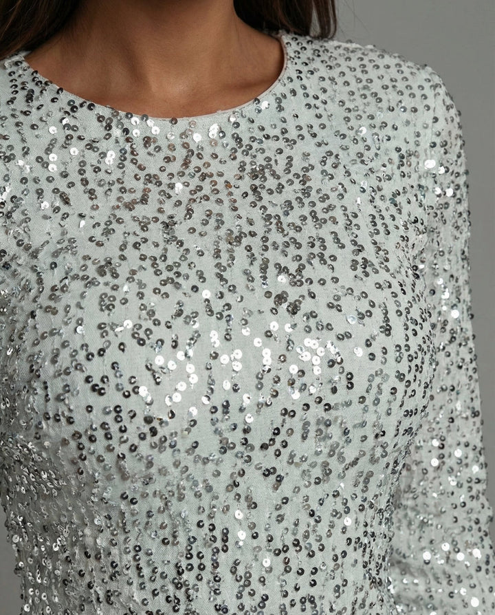 Trendy women's sequin mini dress featuring a stylish open back & long sleeves. Perfect party or holiday dress.