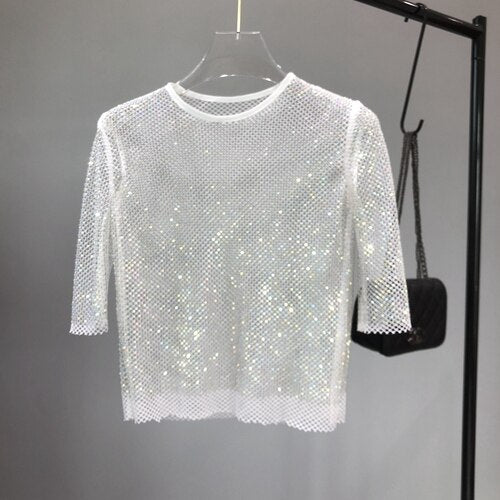 Women's metallic glitter party top, perfect for nights out. Shimmering, casual glam fashion.