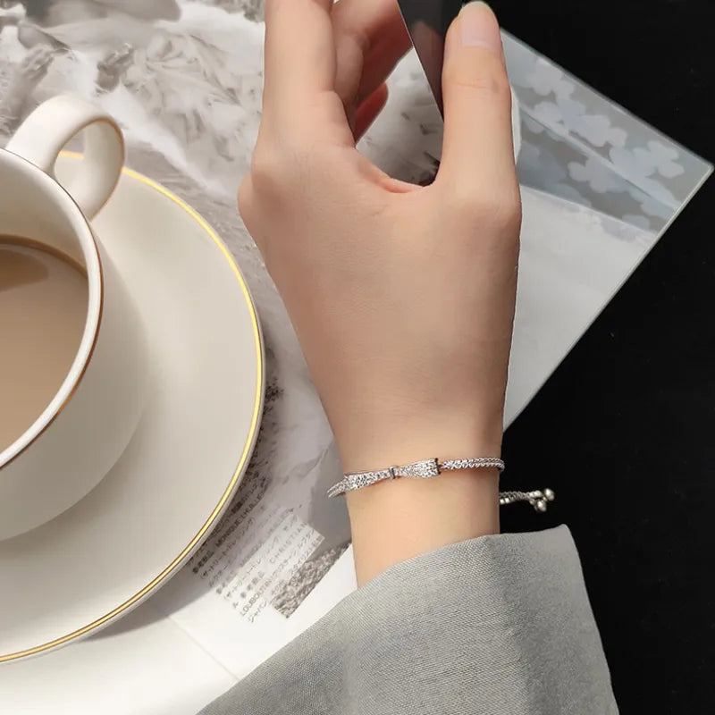 Sparkling silver tennis bracelet for women, set with dazzling zirconia stones. Elegant fashion accessory.