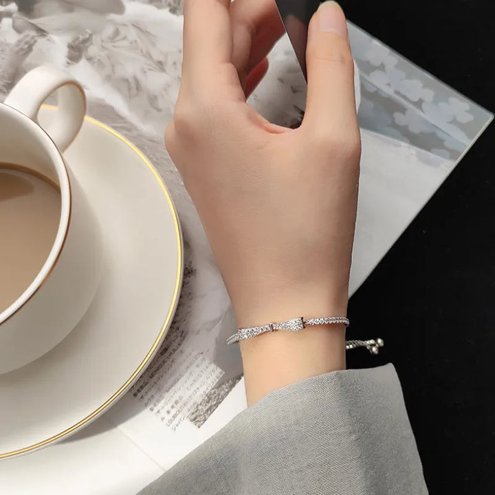 Sparkling silver tennis bracelet for women, set with dazzling zirconia stones. Elegant fashion accessory.