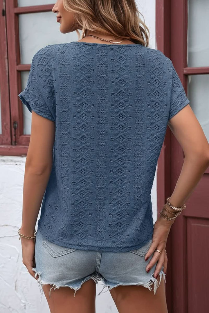 Relaxed fit women's short sleeve t-shirt featuring elegant eyelet details and a chic notched neck.