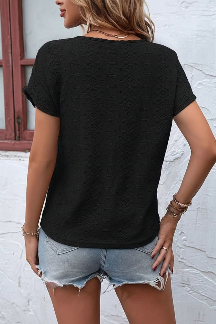 Delicate eyelet women's top with a trendy notched neck, a versatile short sleeve for any casual look.