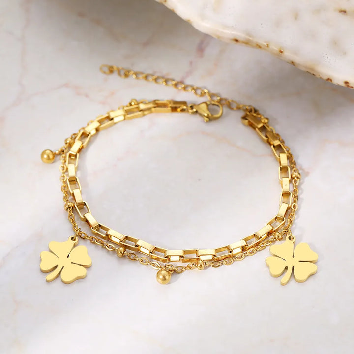 Women's delicate four-leaf clover bracelet in gold & silver, a lucky charm perfect for everyday elegance.