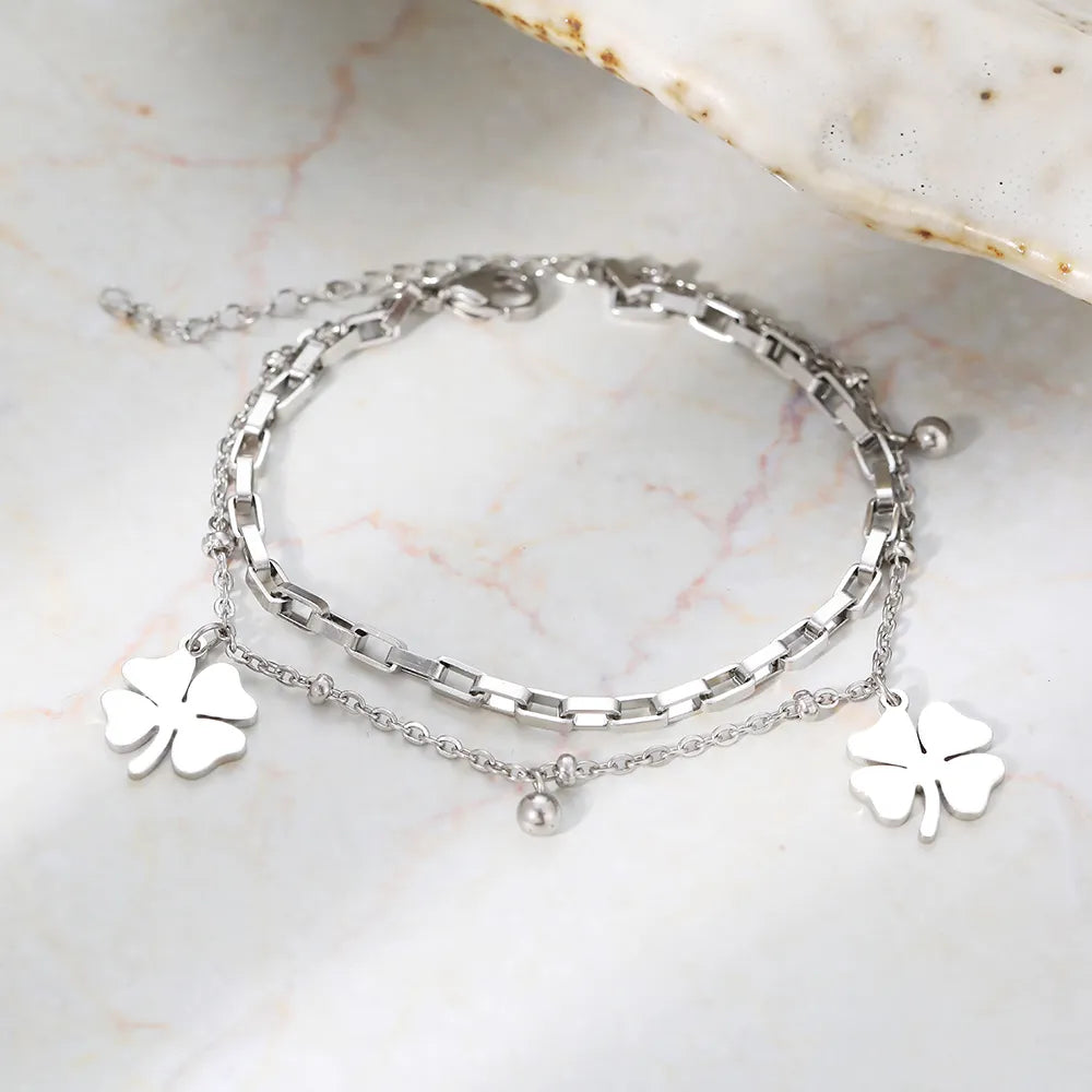 Elegant gold bracelet for women featuring a shimmering four-leaf clover charm, a meaningful lucky jewelry piece.