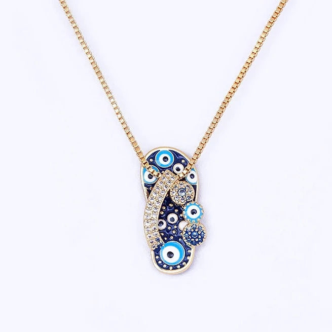 Elegant gold women's necklace featuring a shiny flip flop and a vibrant evil eye pendant for stylish daily and beach wear.