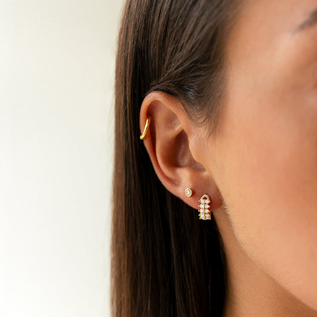 Gold plated women's compact circle earrings, minimalist design with dazzling zirconia stones.