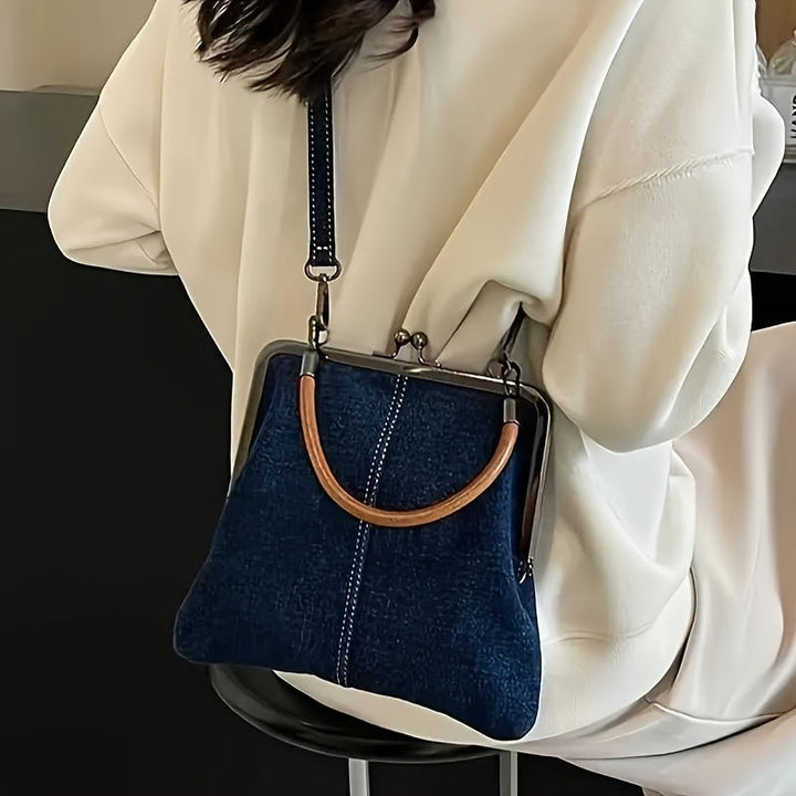 Light wash indigo denim frame shoulder bag for women, featuring a chic leather handle and vintage-inspired design.