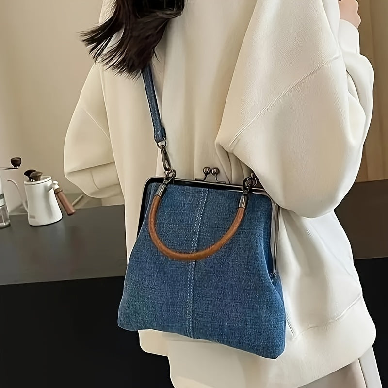 Stylish women's frame shoulder bag with indigo denim body & contrasting brown leather handle. Vintage fashion accessory.