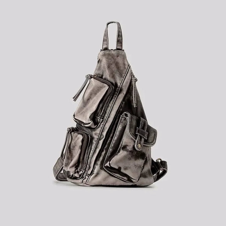 Women's distressed convertible backpack, can be worn as a sling or chest bag. Fashionable & versatile travel accessory.