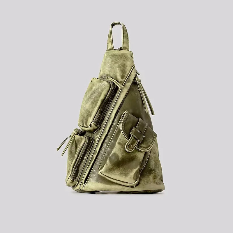 Women's convertible travel backpack in distressed style. Functions as a sling or chest bag for ultimate versatility.