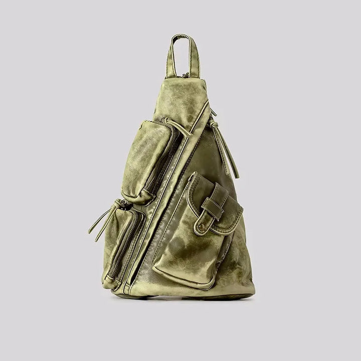 Women's convertible travel backpack in distressed style. Functions as a sling or chest bag for ultimate versatility.
