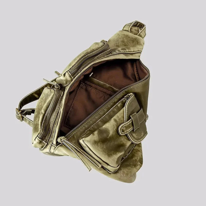 Distressed women's convertible backpack. Transforms into a stylish sling or chest bag. Ideal for travel & daily use.
