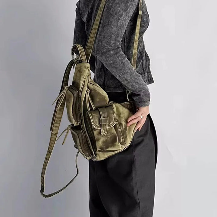 Trendy women's distressed convertible backpack. Versatile design as a sling, chest bag, or stylish travel accessory.