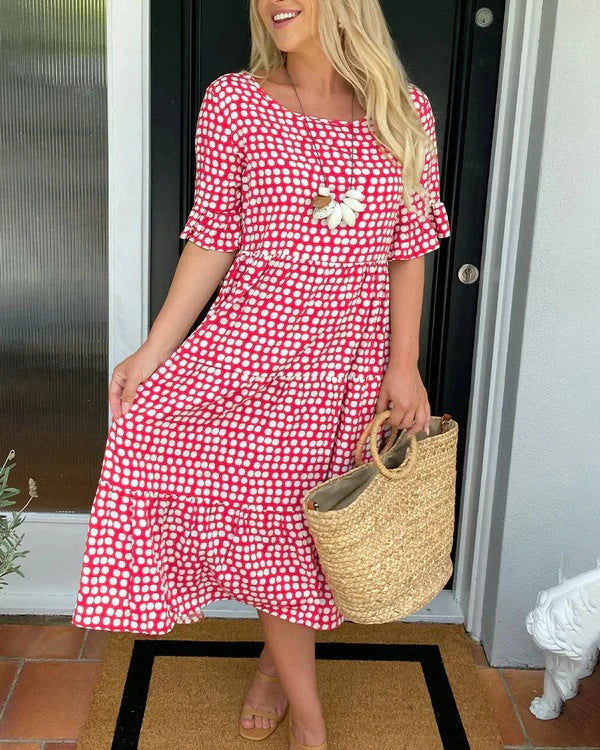 Women's dotted midi dress, relaxed fit, short sleeve, round neck. Perfect for casual summer style.