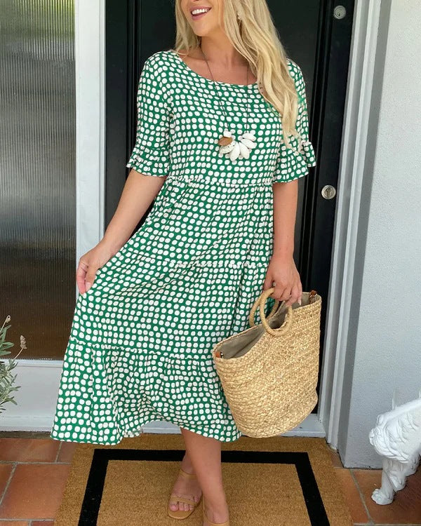 Summer-ready women's dotted midi dress with a relaxed fit and effortless style. Versatile casual wear.