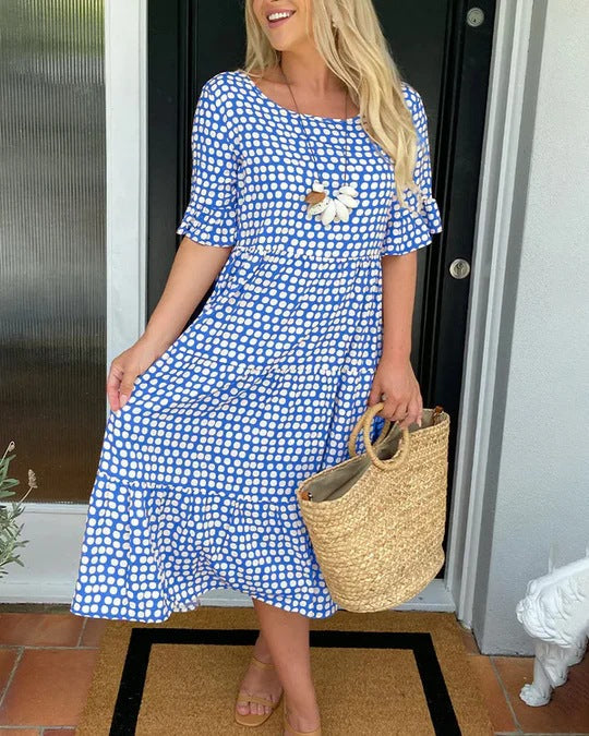 Tiered women's midi dress with a stylish dotted pattern, round neck, and short sleeves. Relaxed fit.