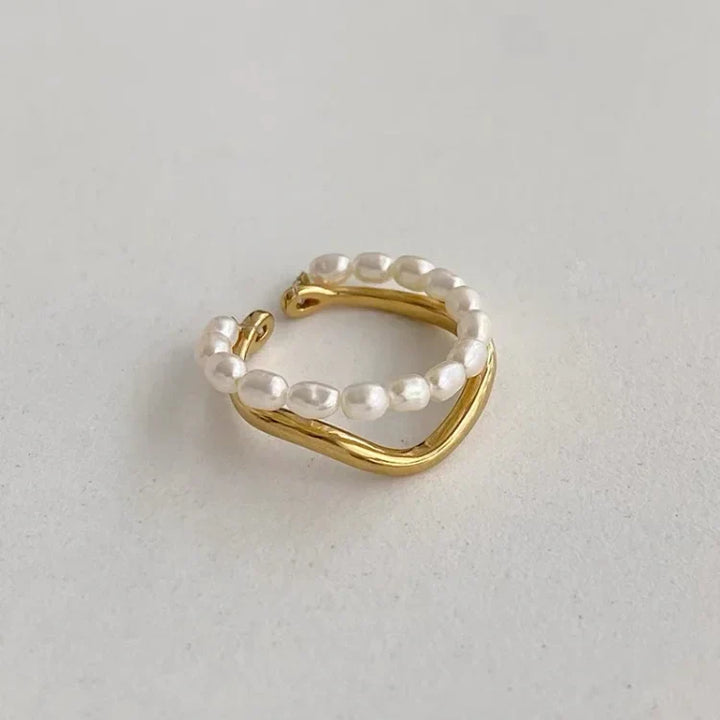 Sophisticated women's double gold ring, adorned with a delicate freshwater pearl. Perfect elegant jewelry gift.