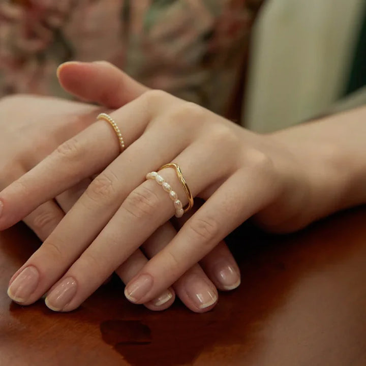 Stunning double layered gold ring with a real freshwater pearl. Elegant women's jewelry, ideal as a gift.