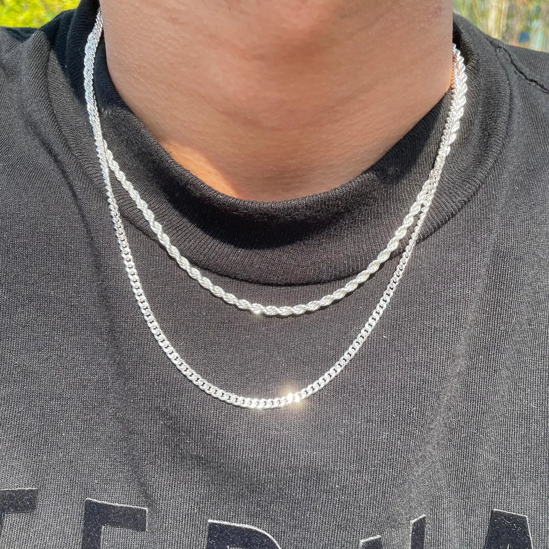 Women's double-layered sterling silver chain necklace featuring delicate curb and rope chains. Elegant silver jewelry.