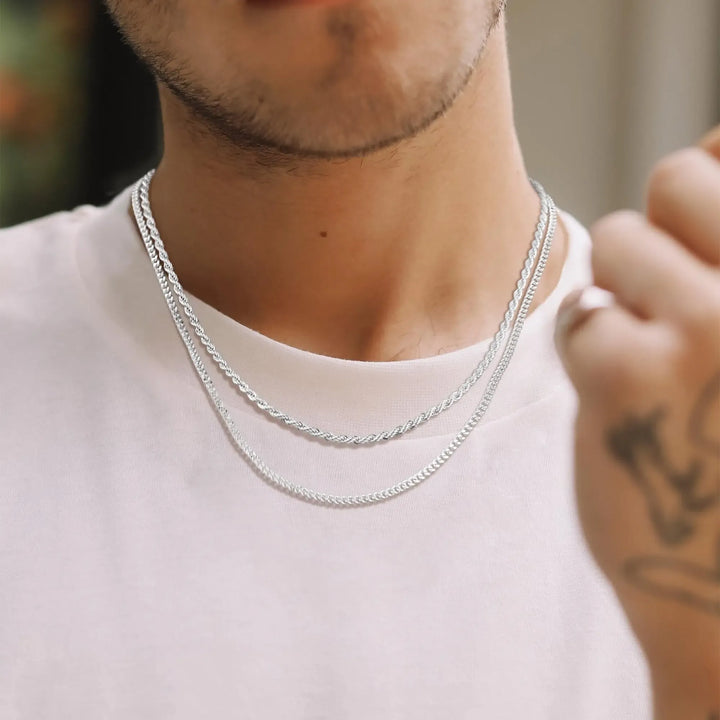 Sterling silver double chain necklace for women, combining a sleek curb chain with a twisted rope chain, layered style.