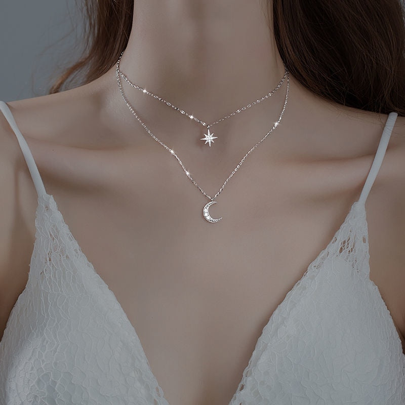 Elegant women's layered sterling silver necklace featuring two delicate moon pendants, a stunning piece of celestial jewelry.