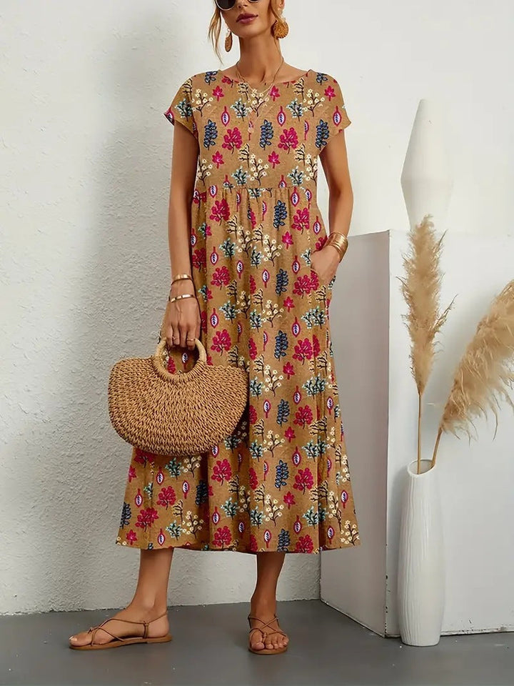 Elegant women's Eden floral midi dress featuring a flattering A-line cut, short sleeves, and vibrant print.