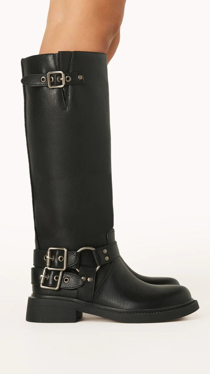 Detailed view of women's black combat boots, showcasing edgy buckles, sturdy sole & durable design.
