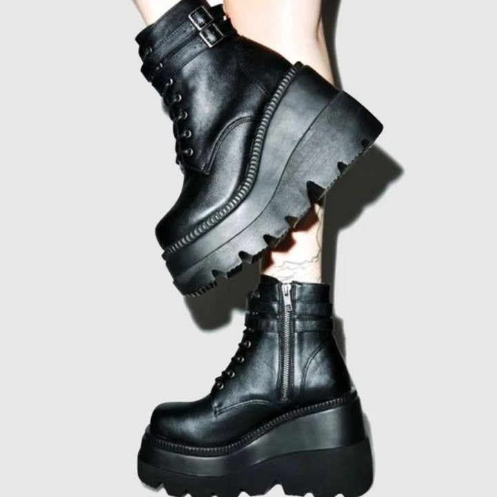 Gothic-inspired women's platform ankle boots; edgy black footwear with a chunky sole for bold style.