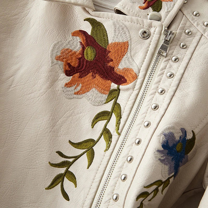 Women's fashion jacket: edgy, floral embroidered, studded, with a modern silhouette.