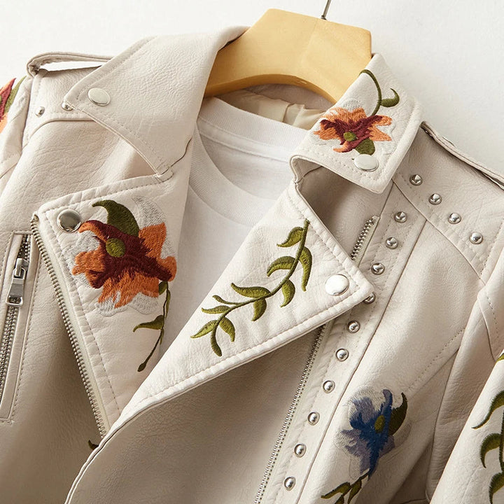 Detailed studs & floral embroidery on an edgy women's black jacket with notched collar.