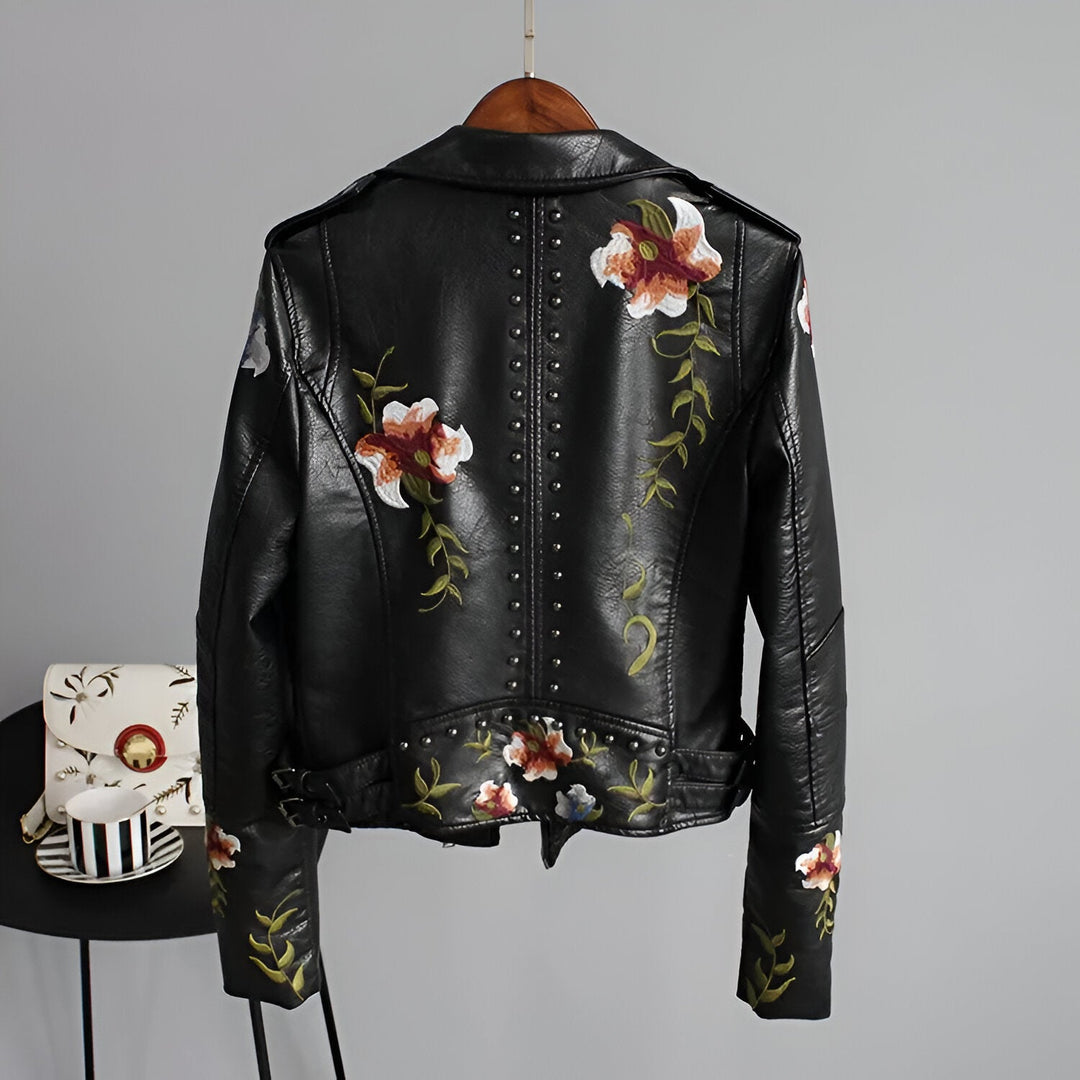 Intricate floral embroidery & studs on an edgy women's black jacket with asymmetrical zipper.