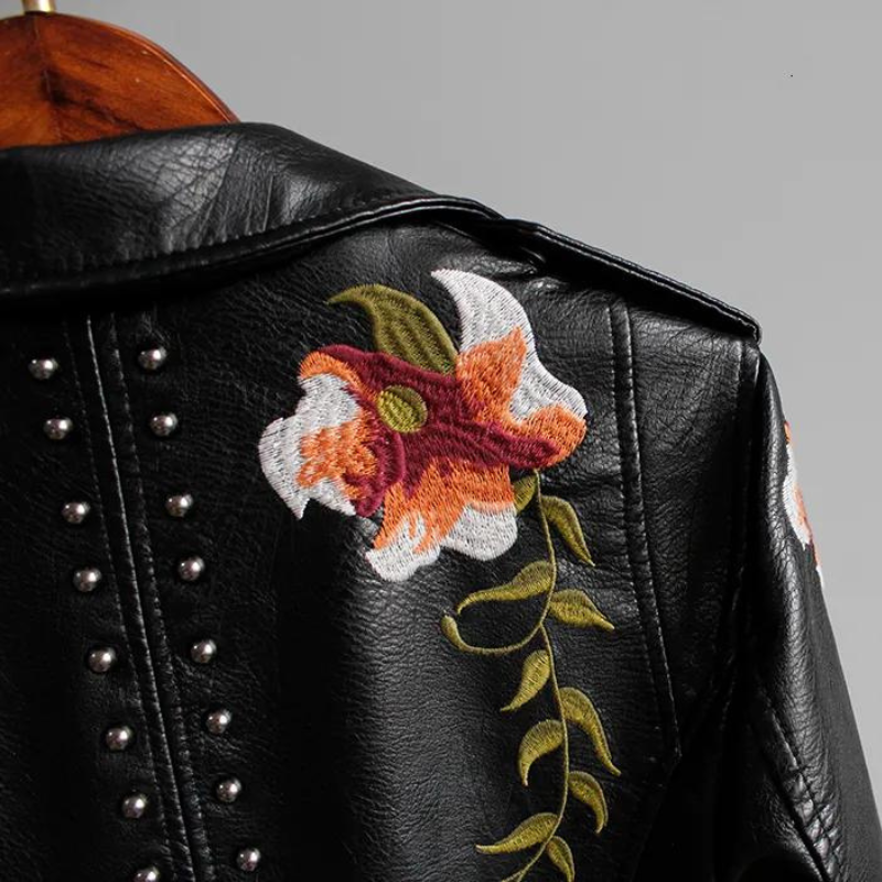 Asymmetrical zipper & notched collar on a chic women's edgy floral embroidered studded jacket.