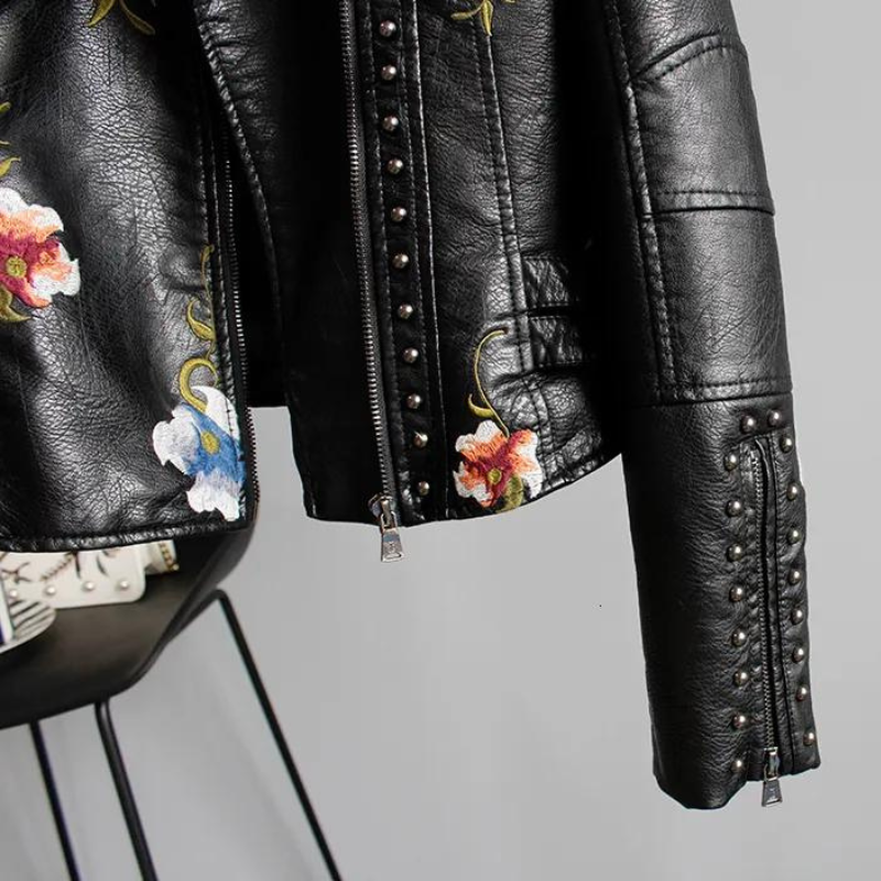 Black edgy women's jacket with floral embroidery & studs, perfect statement outerwear.