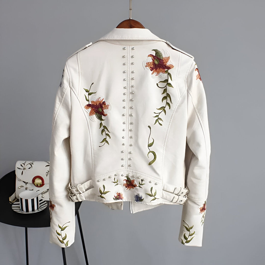 Women's white edgy studded jacket with delicate floral embroidery for a bold look.