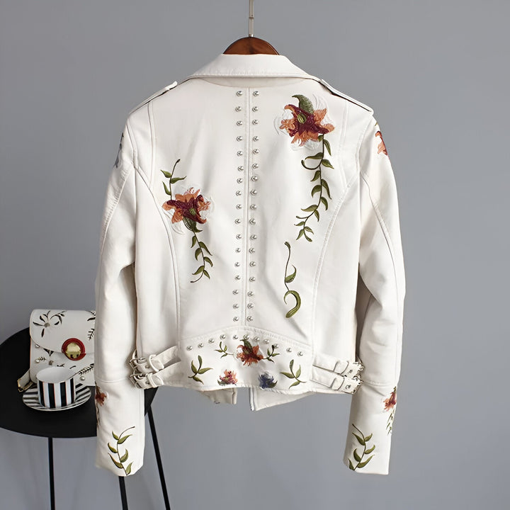 Women's white edgy studded jacket with delicate floral embroidery for a bold look.