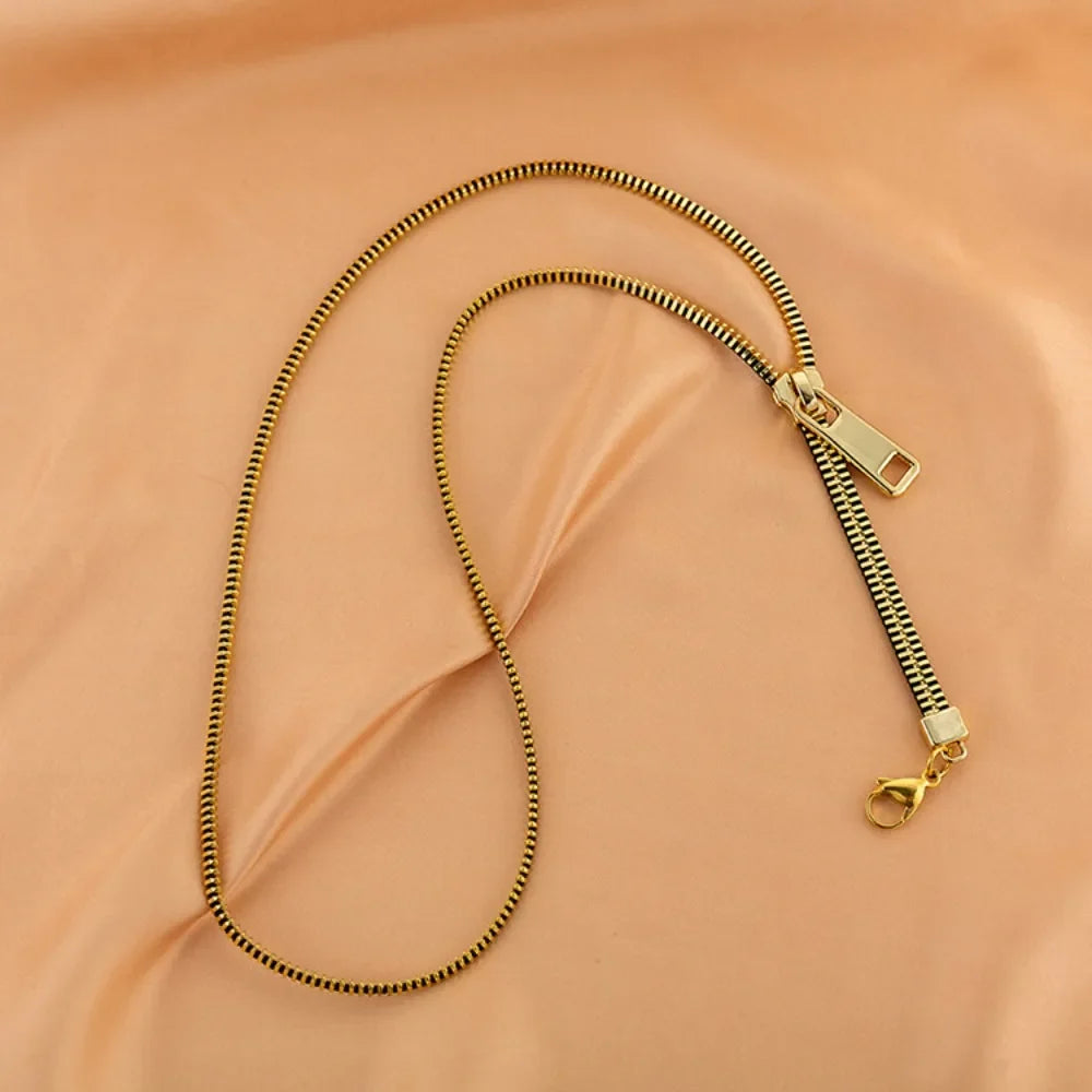 Trendy women's zip chain necklace, a metallic statement fashion accessory for an edgy look.
