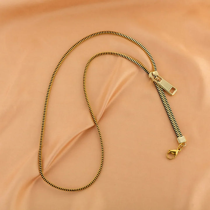 Trendy women's zip chain necklace, a metallic statement fashion accessory for an edgy look.