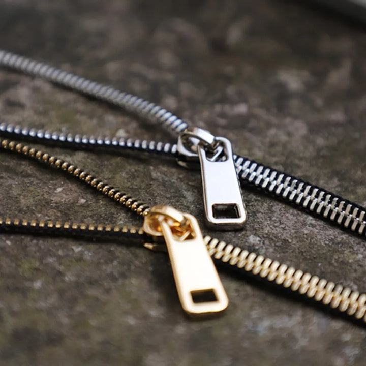 Unique women's zip chain statement necklace, featuring an edgy metallic design in gold for fashionistas.