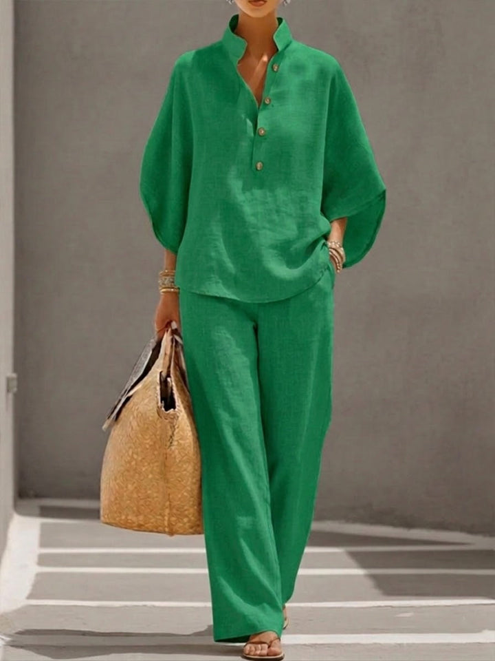 Elegant women's two-piece set featuring a batwing sleeve blouse and comfortable wide leg trousers.