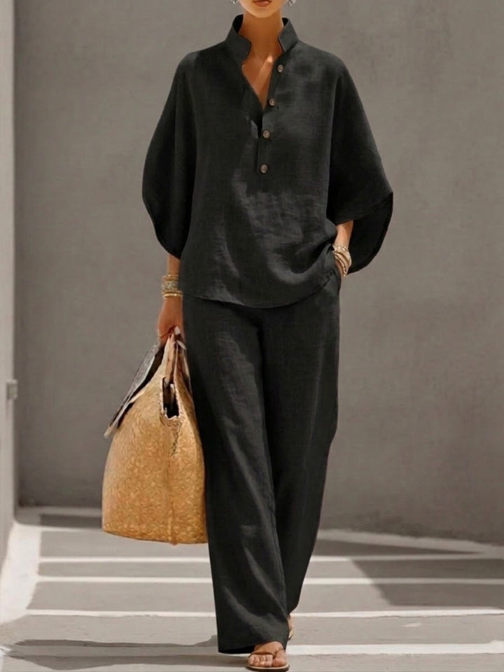 Women's button-front batwing blouse and wide leg trousers two-piece set for elegant, versatile fashion.