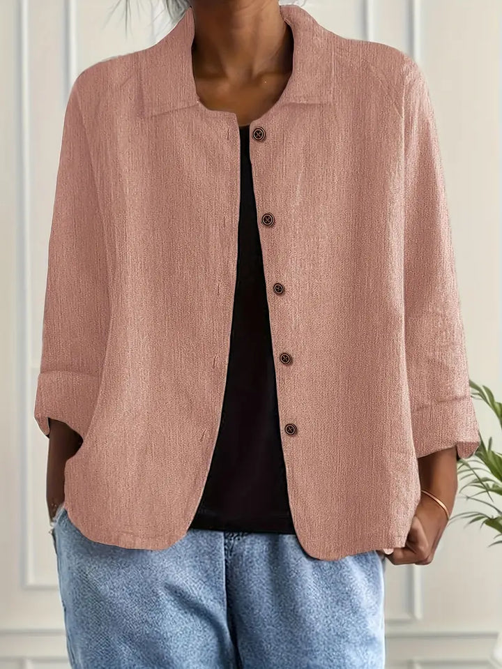 Relaxed fit women's button-front top with three-quarter sleeves for versatile casual wear.