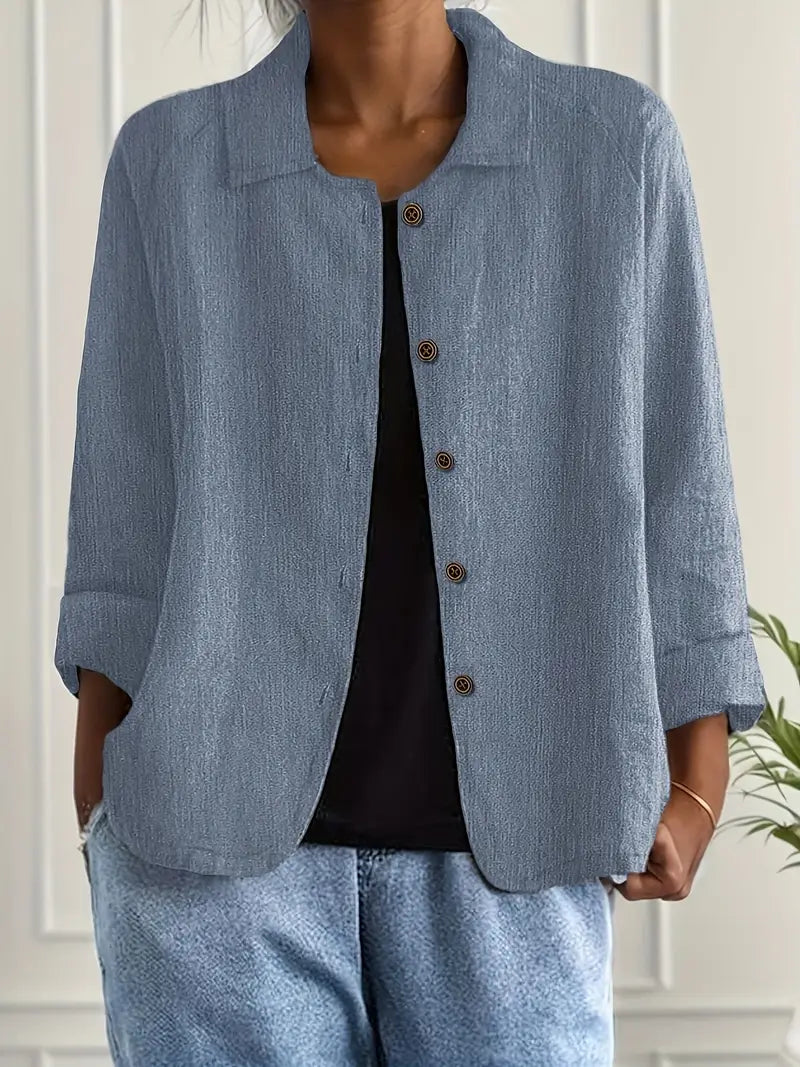Collared women's button-front top with three-quarter sleeves, offering easy care & style.